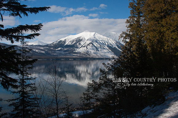 Mount Vaught framed by trees as seen from the east shore of Lake McDonald - Glacier National Park