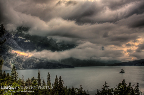 Beams of sunlight filter through the clouds over St. Mary Lake - Glacier National Park