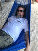man lounging in a hammock