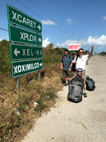 travelers standing near highway sign in the Yucatan peninsula